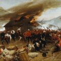 Pintura de Alphonse de Neuville que representa la batalla de Rorke's Drift, donde soldados británicos en uniformes rojos defienden una posición contra los guerreros zulúes.